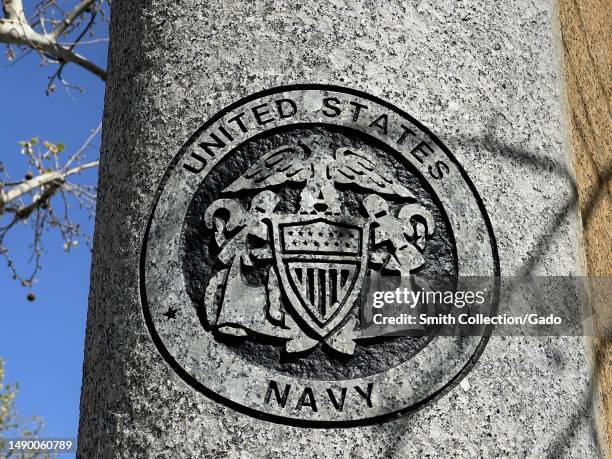 United States Navy emblem on a circular surface with surrounding trees, sky visible in the background, Walnut Creek, California, April 18, 2023.