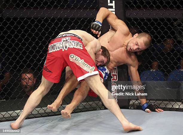 Mitch Clarke takes down Anton Kuivanen during their lightweight bout at UFC 149 inside the Scotiabank Saddledome on July 21, 2012 in Calgary,...