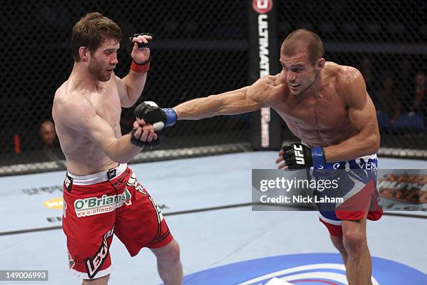 Anton Kuivanen throws a punch at Mitch Clarke during their lightweight bout at UFC 149 inside the Scotiabank Saddledome on July 21, 2012 in Calgary,...