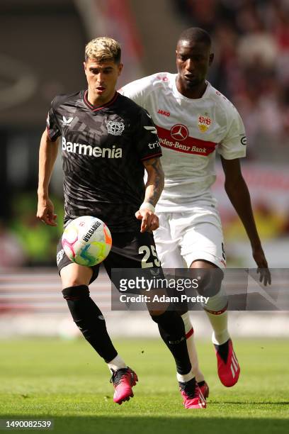 Exequiel Palacios of Bayer 04 Leverkusen controls the ball whilst under pressure from Sehrou Guirassy of VfB Stuttgart during the Bundesliga match...