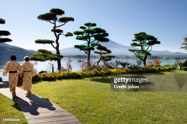 mother and daughter walking in garden, rear - in a japanese garden stock pictures, royalty-free photos & images