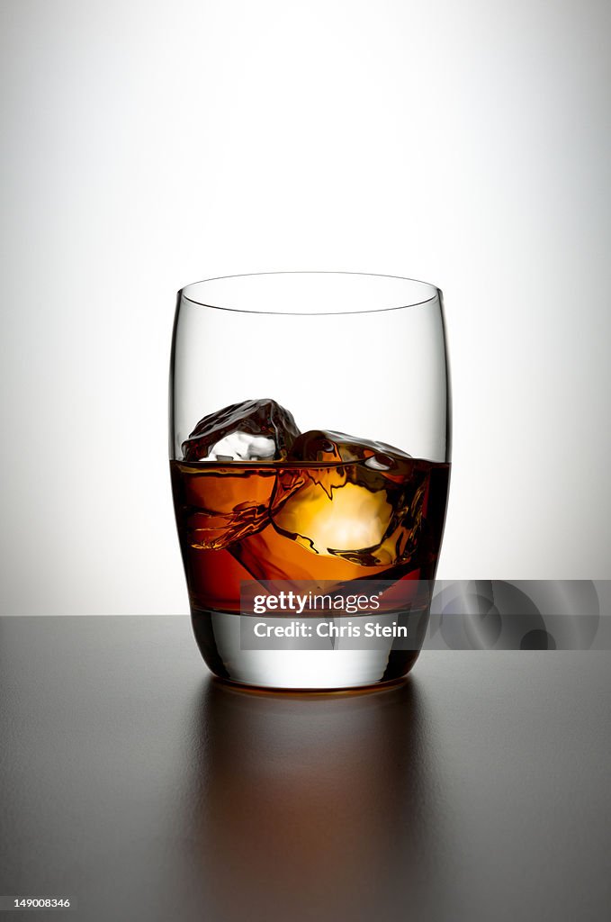 Glass with Brown Liquor and ice cubes