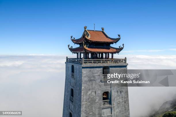 aerial view of kim son bao thang tu fort at the top of fanispan mountain, sa pa, lao cai, vietnam with sunlight and fog - giant buddha stock pictures, royalty-free photos & images