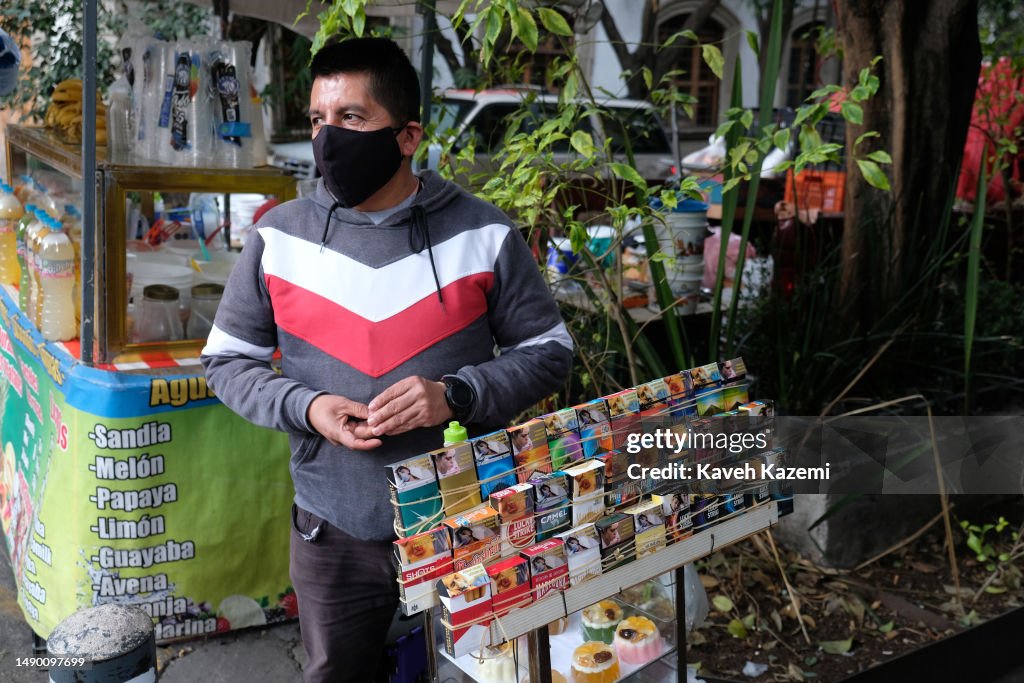 A man wearing a protective facial mask for COVID-19 sells Marlboro