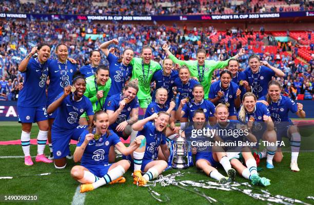 Players of Chelsea pose for a team photograph with their Winners Medals and the Vitality Women's FA Cup in front of their fans after defeating...