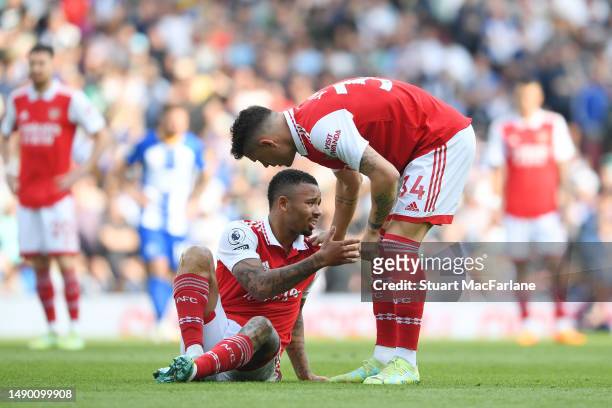 Gabriel Jesus of Arsenal goes down with an injury and is helped up by teammate Granit Xhaka during the Premier League match between Arsenal FC and...