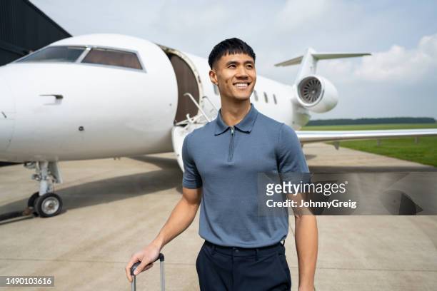 successful asian businessman travelling on private jet - berkshire england stock pictures, royalty-free photos & images
