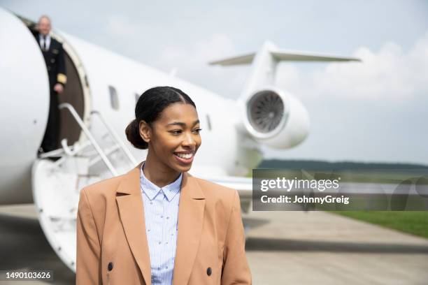 young black businesswoman travelling on private jet - berkshire england stock pictures, royalty-free photos & images