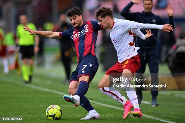 Riccardo Orsolini of Bologna FC competes for the ball with Nicola Zalewski of AS Roma during the Serie A match between Bologna FC and AS Roma at...