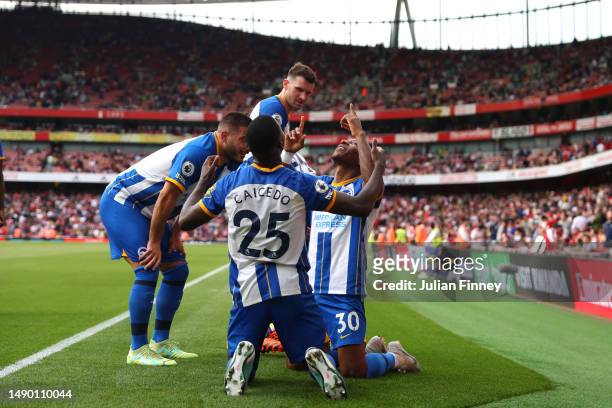 Pervis Estupinan of Brighton & Hove Albion celebrates with teammates after scoring the team's third goal during the Premier League match between...