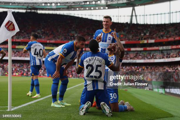 Pervis Estupinan of Brighton & Hove Albion celebrates with teammates after scoring the team's third goal during the Premier League match between...