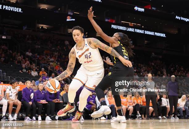 Brittney Griner of the Phoenix Mercury handles the ball against Chiney Ogwumike of the Los Angeles Sparks during the first half of the WNBA game at...