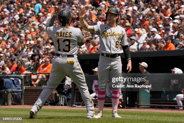 Ke'Bryan Hayes of the Pittsburgh Pirates and Jack Suwinski celebrate after scoring on a single hit by Ji Hwan Bae during the third inning in a game...