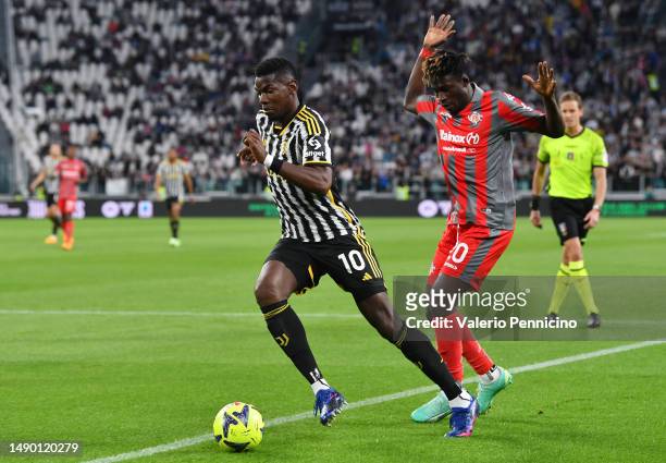 Paul Pogba of Juventus runs with the ball whilst under pressure from Felix Afena-Gyan of US Cremonese during the Serie A match between Juventus and...