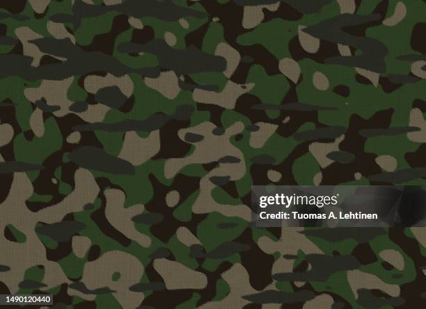 close-up of green camouflage pattern on a burlap cloth. - tenue de camouflage mode photos et images de collection