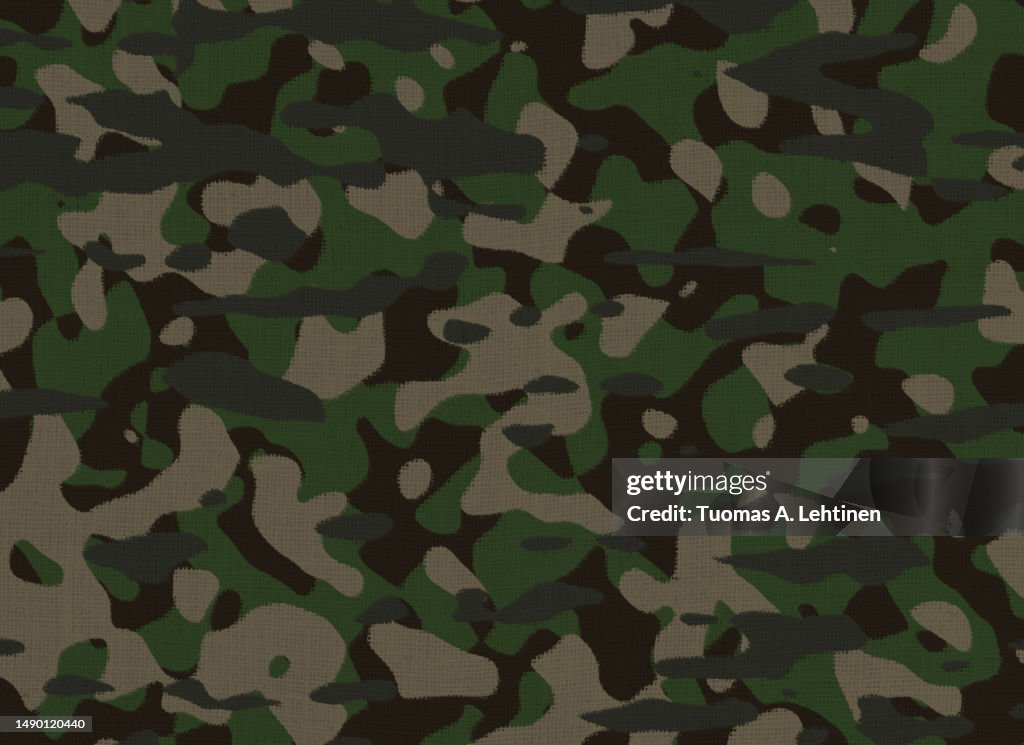 Close-up of green camouflage pattern on a burlap cloth.
