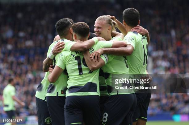 Erling Haaland of Manchester City celebrates with team mates after scoring the team's second goal during the Premier League match between Everton FC...