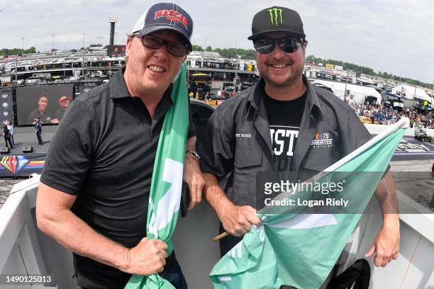 Honorary starters and former NASCAR Cup Series drivers Ricky Craven and Kurt Busch pose with the green flag in the flagstand prior to the NASCAR Cup...