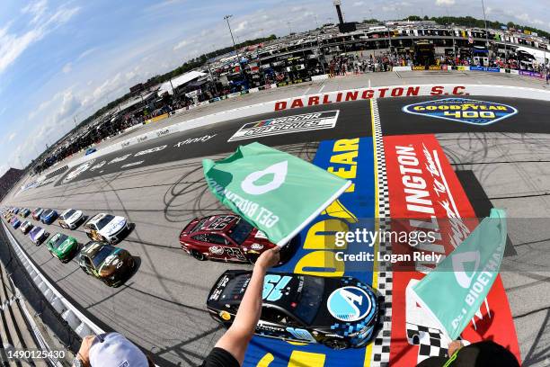 Martin Truex Jr., driver of the Auto-Owners Insurance Toyota, leads the field to the green flag to start the NASCAR Cup Series Goodyear 400 at...