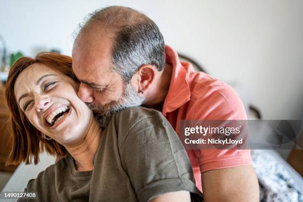 romantic mature couple spending time together at home - good morning kiss images stock pictures, royalty-free photos & images