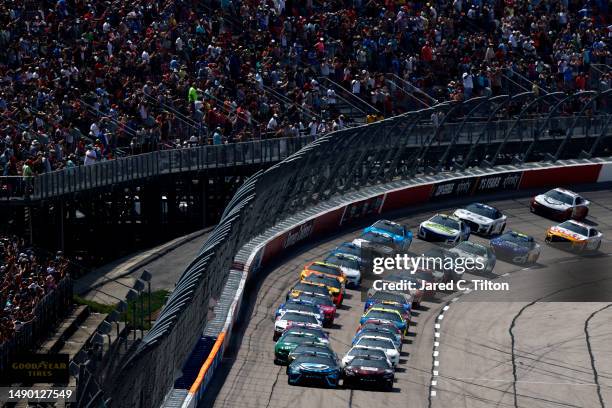 Martin Truex Jr., driver of the Auto-Owners Insurance Toyota, and Bubba Wallace, driver of the Dr Pepper Toyota, lead the field to the green flag to...