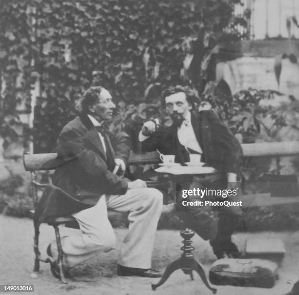 Danish author Hans Christian Andersen at an outdoor table with an unidentified man, 19th century.