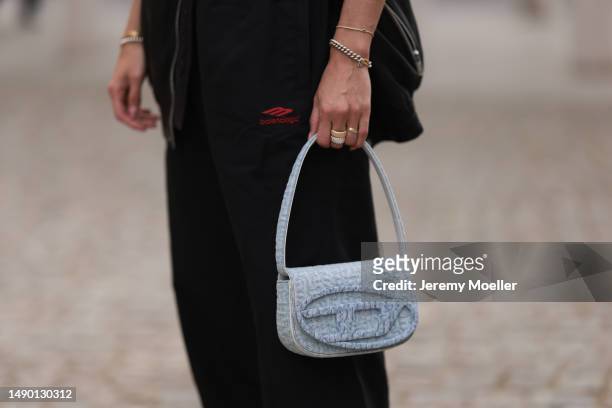 Nadine Berneis seen wearing Young poets black leather oversized vest, Prada platform black and white logo sneaker, Balenciaga nylon oversized jogging...