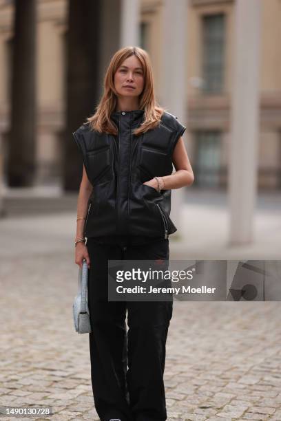 Nadine Berneis seen wearing Young poets black leather oversized vest, Prada platform black and white logo sneaker, Balenciaga nylon oversized jogging...