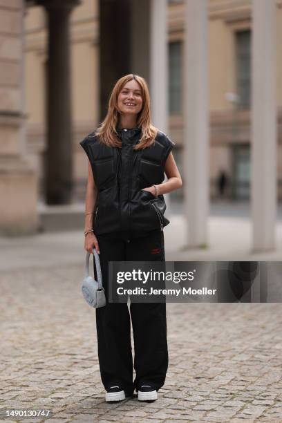 Nadine Berneis seen wearing Young poets black leather oversized vest, Prada platform black and white logo sneaker, Balenciaga nylon oversized jogging...