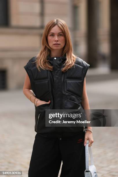 Nadine Berneis seen wearing Young poets black leather oversized vest, Prada platform black and white logo sneaker, Balenciaga nylon oversized jogging...