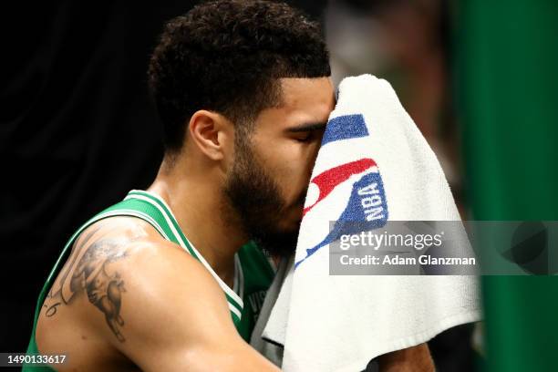 Jayson Tatum of the Boston Celtics wipes his face with a towel against the Philadelphia 76ers during the first quarter in game seven of the 2023 NBA...