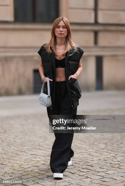 Nadine Berneis seen wearing Young poets black leather oversized vest, Prada platform black and white logo sneaker, Balenciaga nylon oversized jogging...