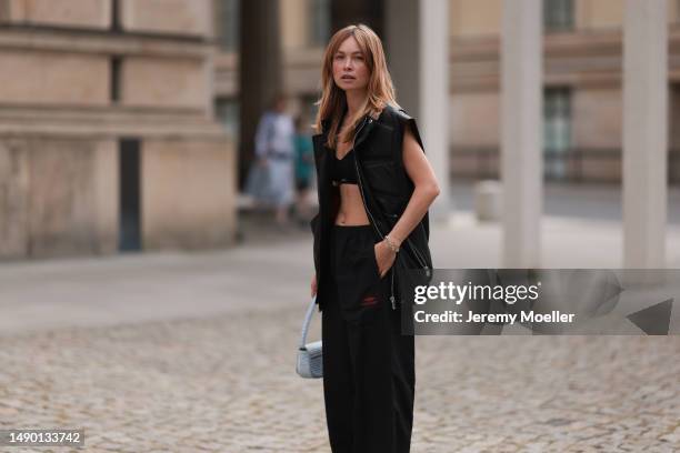 Nadine Berneis seen wearing Young poets black leather oversized vest, Prada platform black and white logo sneaker, Balenciaga nylon oversized jogging...