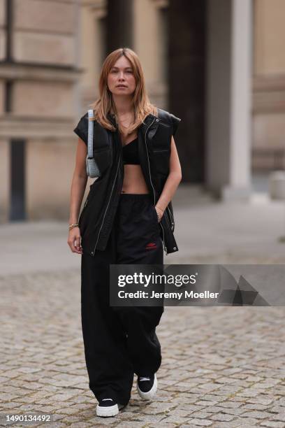 Nadine Berneis seen wearing Young poets black leather oversized vest, Prada platform black and white logo sneaker, Balenciaga nylon oversized jogging...