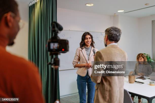 joyful businesswoman giving interview to tv. - media interview stock pictures, royalty-free photos & images