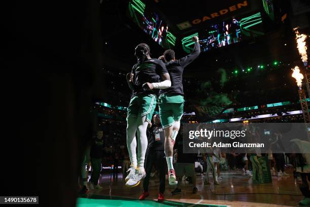 Jaylen Brown and Jayson Tatum of the Boston Celtics jump during player introductions prior to game seven of the 2023 NBA Playoffs Eastern Conference...