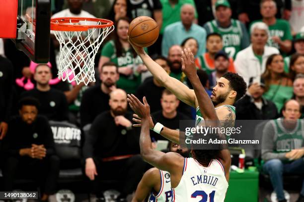 Jayson Tatum of the Boston Celtics shoots the ball against Joel Embiid of the Philadelphia 76ers during the second quarter in game seven of the 2023...