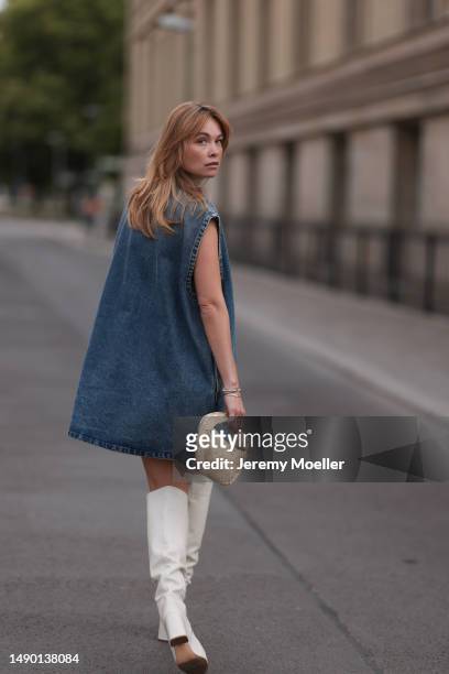 Nadine Berneis seen wearing Prada blue denim midi logo dress, Zara beige over knee boots, Bottega Veneta mini Jodie porridge beige leather bag on May...