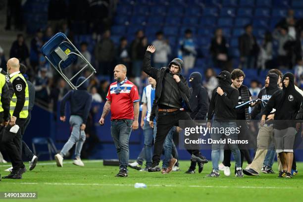 Fan of RCD Espanyol is seen throwing a chair on the pitch after the LaLiga Santander match between RCD Espanyol and FC Barcelona at RCDE Stadium on...