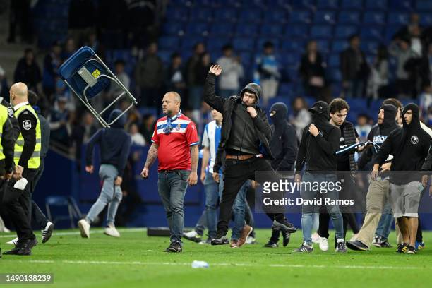 Fan of RCD Espanyol is seen throwing a chair on the pitch after the LaLiga Santander match between RCD Espanyol and FC Barcelona at RCDE Stadium on...