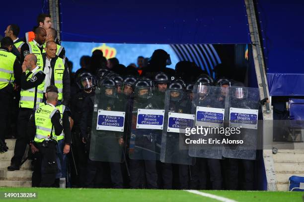 Police protect the locker room tunnel on the pitch after the LaLiga Santander match between RCD Espanyol and FC Barcelona at RCDE Stadium on May 14,...