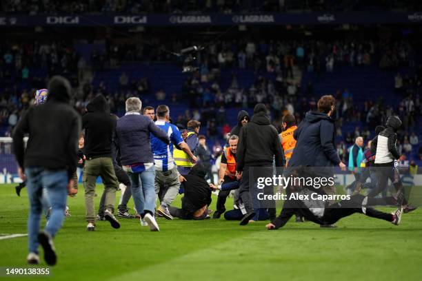 Fans of RCD Espanyol pitch invade after the LaLiga Santander match between RCD Espanyol and FC Barcelona at RCDE Stadium on May 14, 2023 in...