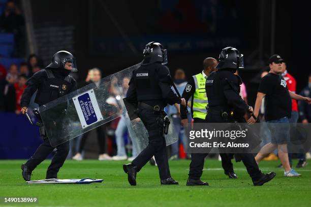 Police are seen on the pitch after the LaLiga Santander match between RCD Espanyol and FC Barcelona at RCDE Stadium on May 14, 2023 in Barcelona,...