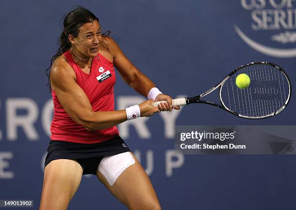 Marion Bartoli of France hits a return to Yung-Jan Chan of Taipei in their semifinal match during day eight of the Mercury Insurance Open Presented...