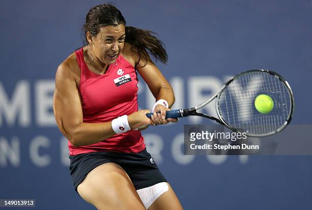 Marion Bartoli of France hits a return to Yung-Jan Chan of Taipei in their semifinal match during day eight of the Mercury Insurance Open Presented...