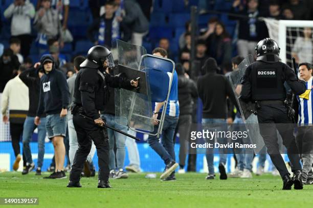 Chair is seen being thrown on the pitch after the LaLiga Santander match between RCD Espanyol and FC Barcelona at RCDE Stadium on May 14, 2023 in...