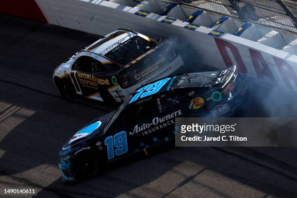 Martin Truex Jr., driver of the Auto-Owners Insurance Toyota spins behind Ross Chastain, driver of the Worldwide Express/UPS Chevrolet, during the...