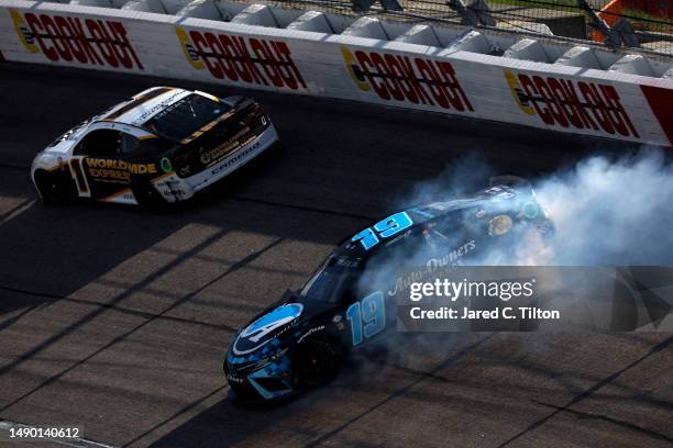 Martin Truex Jr., driver of the Auto-Owners Insurance Toyota spins behind Ross Chastain, driver of the Worldwide Express/UPS Chevrolet, during the...