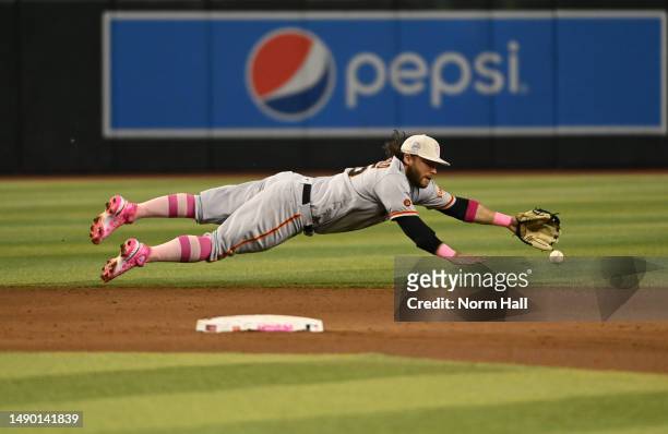 Brandon Crawford of the San Francisco Giants attempts to make a diving play on a single hit by Gabriel Moreno of the Arizona Diamondbacks during the...