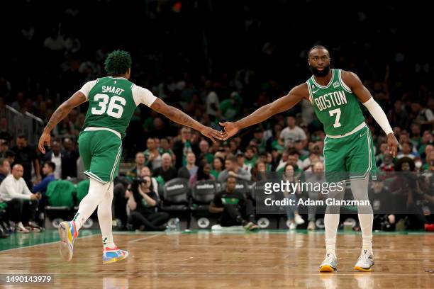Jaylen Brown and Marcus Smart of the Boston Celtics celebrate a basket against the Philadelphia 76ers during the third quarter in game seven of the...